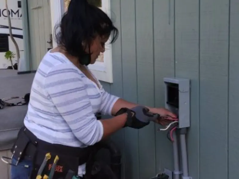 Licensed electrician wiring an exterior subpanel in Ontwa
